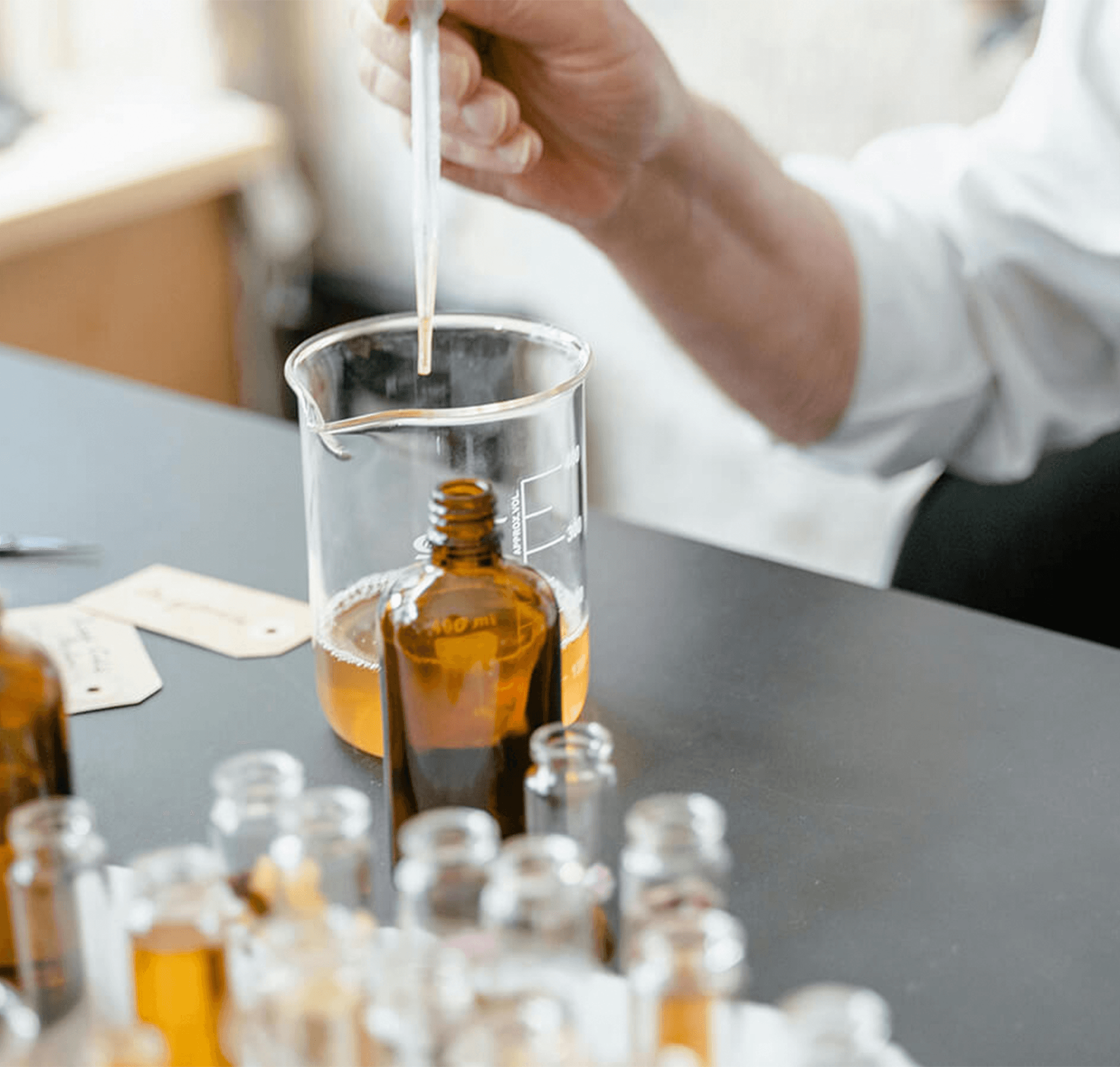 Hand preparing a Zenox fragrance blend